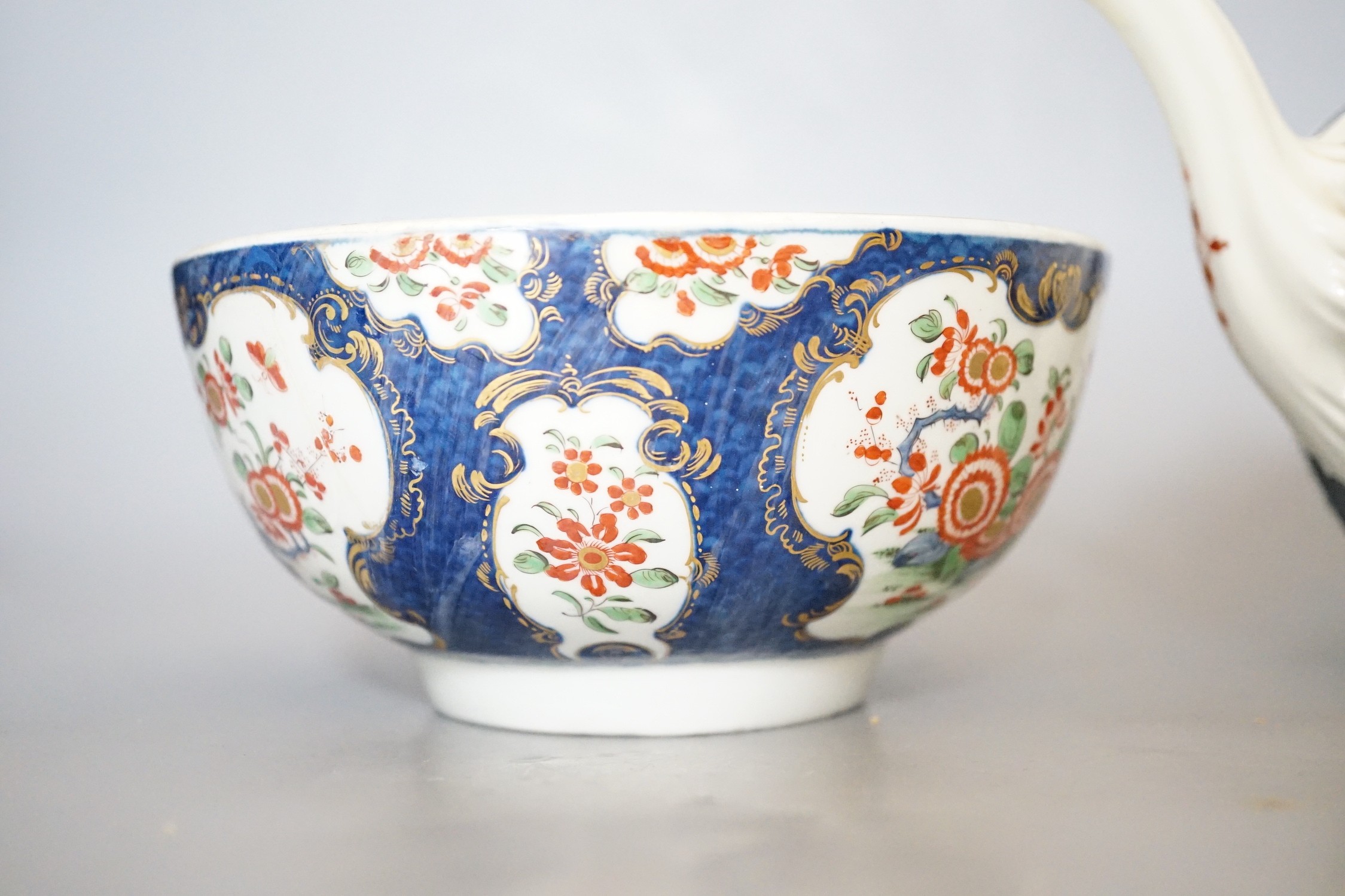 A Worcester teapot and cover, painted in the manner of the red line border group with the Queens pattern and a Worcester blue scale bowl painted with kakiemon flowers, teapot and cover 16cms high